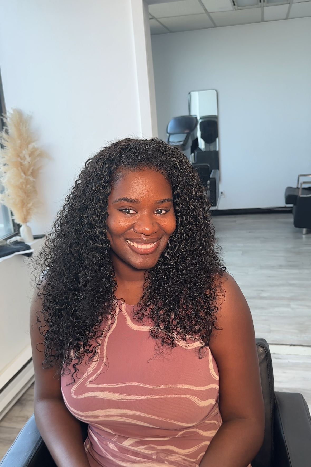 Client wearing installed Burmese Curly bundles