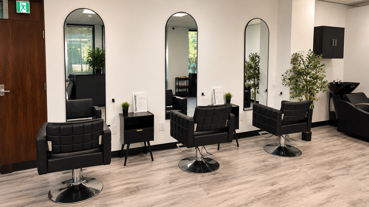 Interior of byBilngwe Beauty Bar in Montréal with styling stations and arched mirrors
