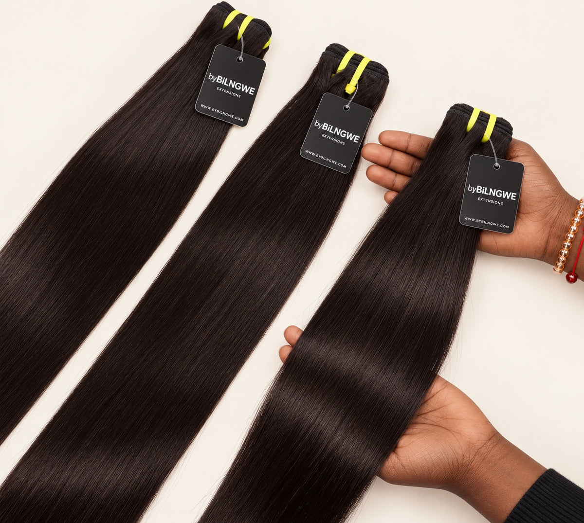 Three byBilngwe Straight bundles with a close-up of one bundle held in hand